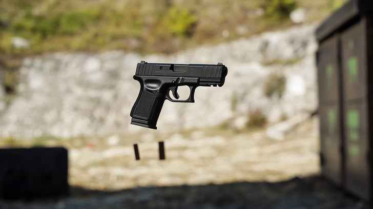 Levitating black handgun Levitating black handgun